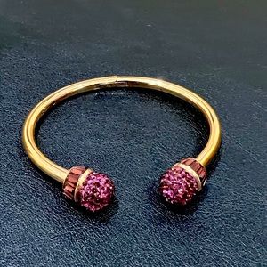 Swarovski rose gold toned cuff/bangle with purple gems.  Gently used.